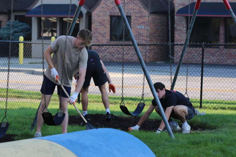 a group of people digging in a playground