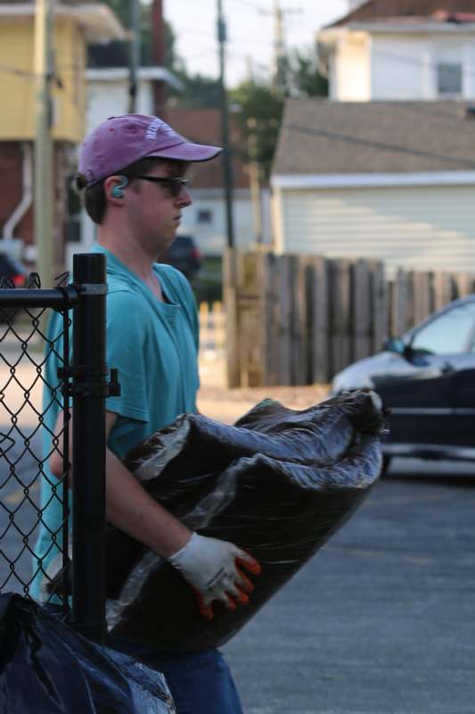 a man carrying a bag of garbage
