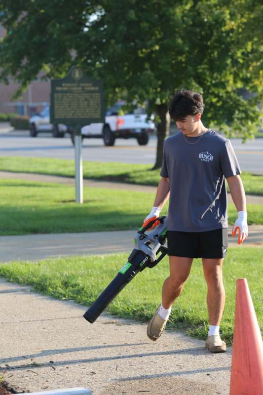 a man holding a leaf blower