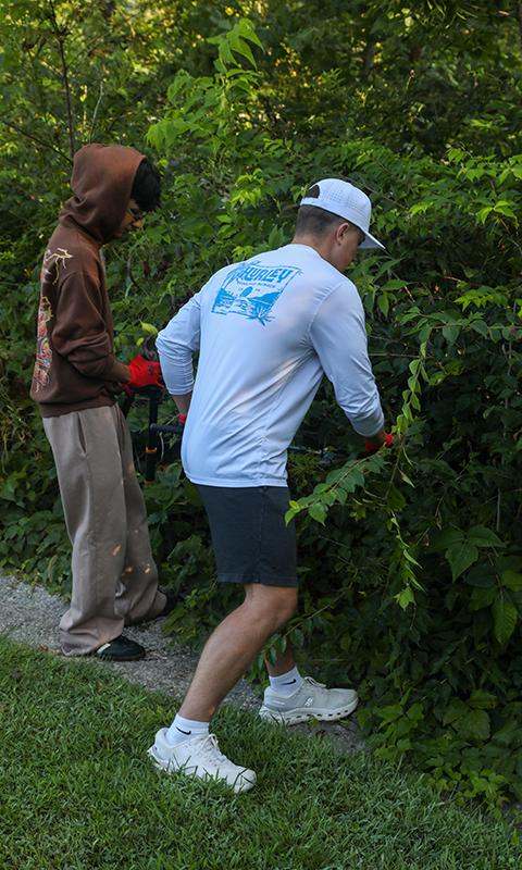 a man holding a hedge trimmer
