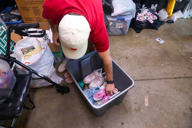 a person putting shoes in a box