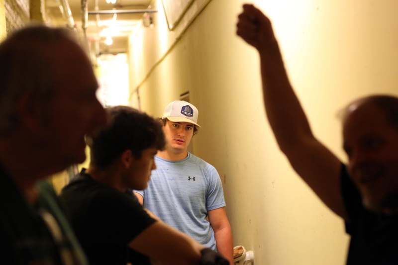 a group of men standing in a hallway