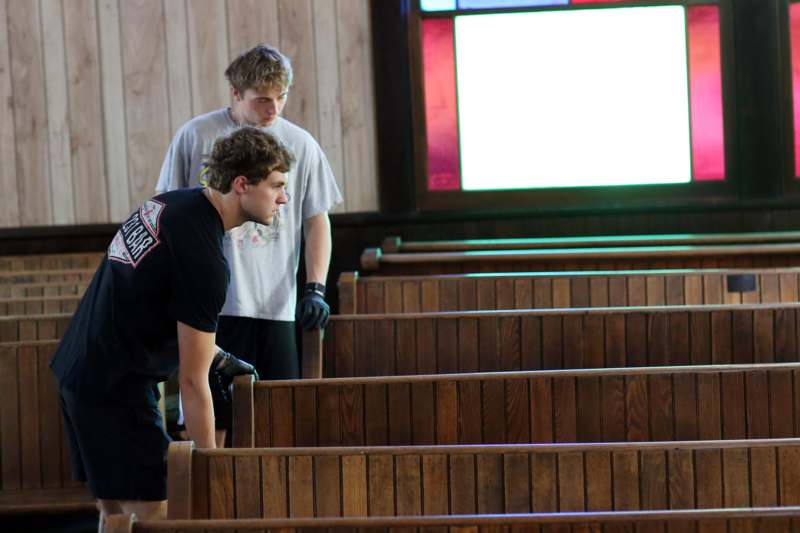a group of men standing in a church pew