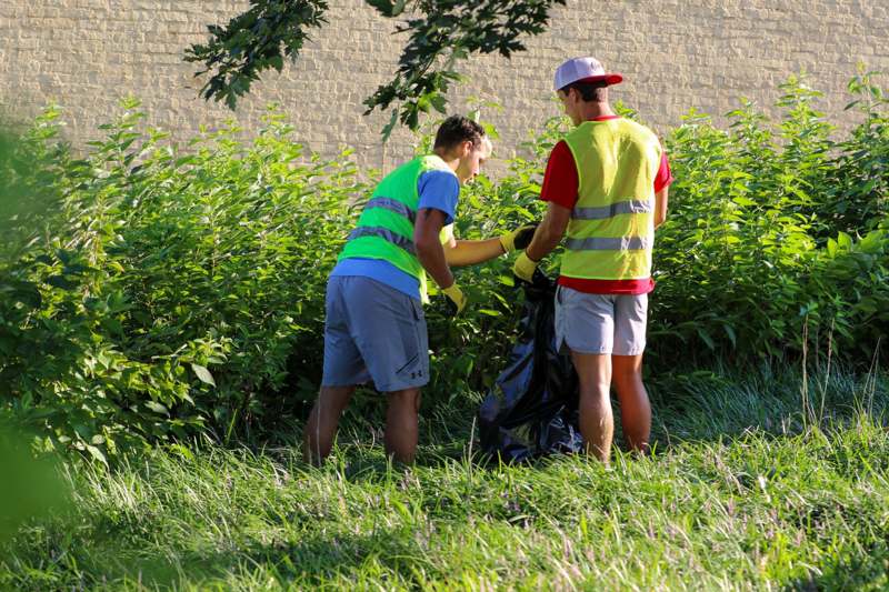 a group of people picking up trash