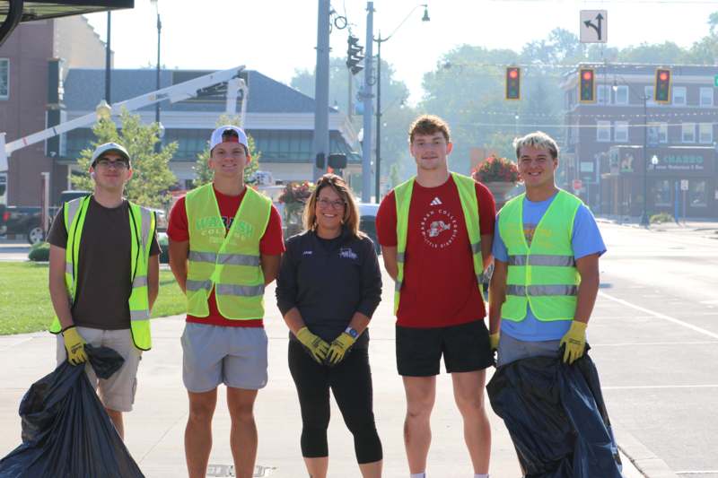 a group of people standing on a sidewalk