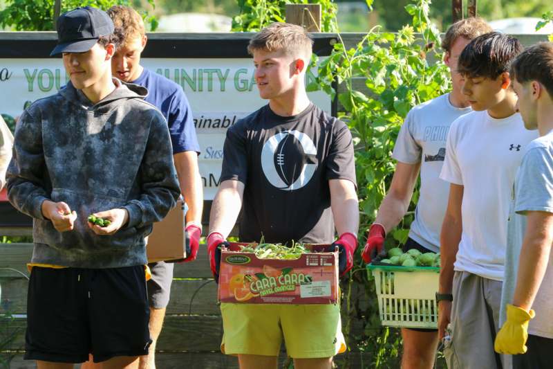 a group of people holding baskets of vegetables