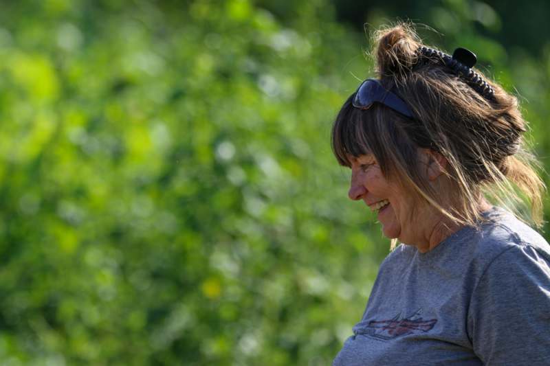 a woman smiling with sunglasses in her hair