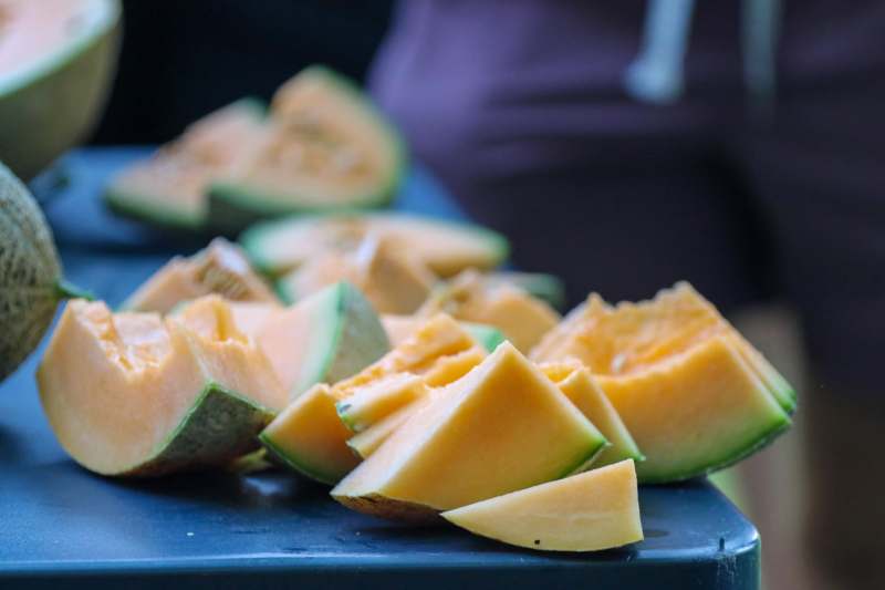 a group of sliced melons on a table