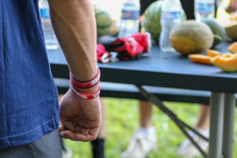 a person's hand with red wristbands
