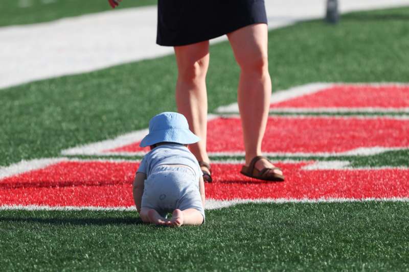 Charlie Finch Alumni Cross Country Run 2026 - a baby crawling on a football field