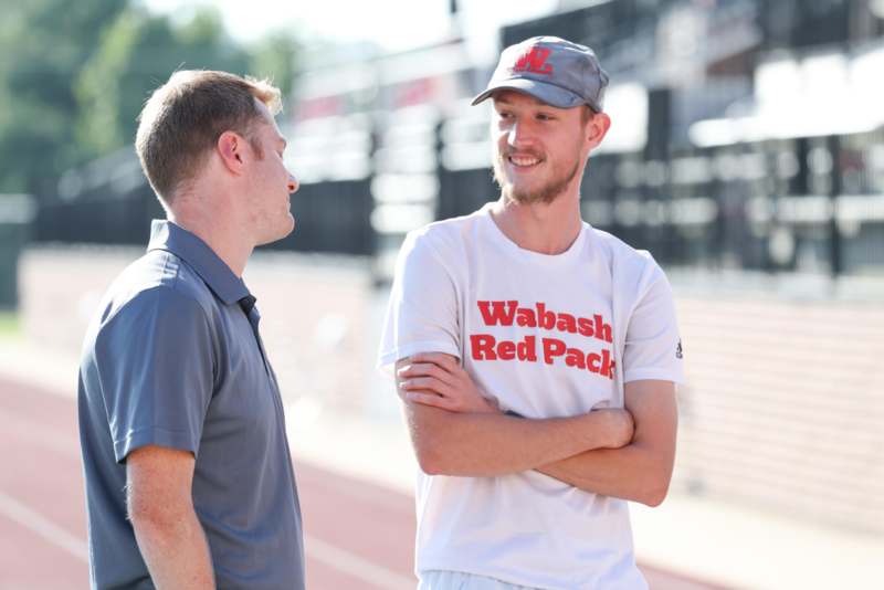two men standing on a track