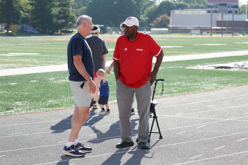 two men standing on a track