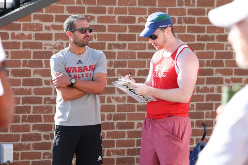 a man standing next to another man