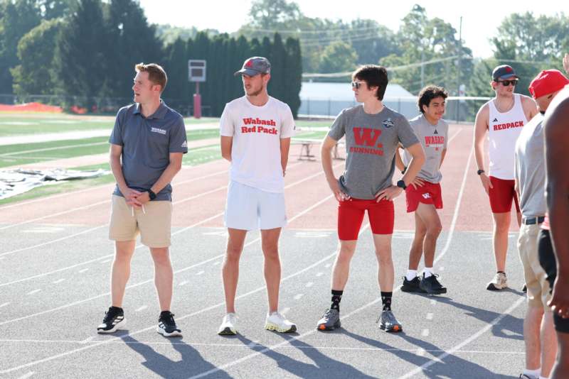 a group of men standing on a track