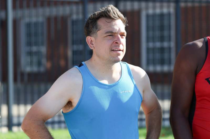 a man in a blue tank top