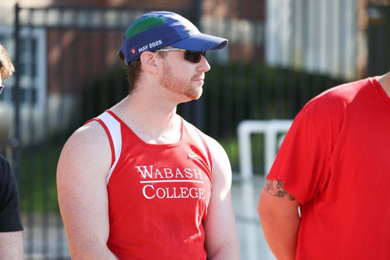 a man in a red shirt and blue hat