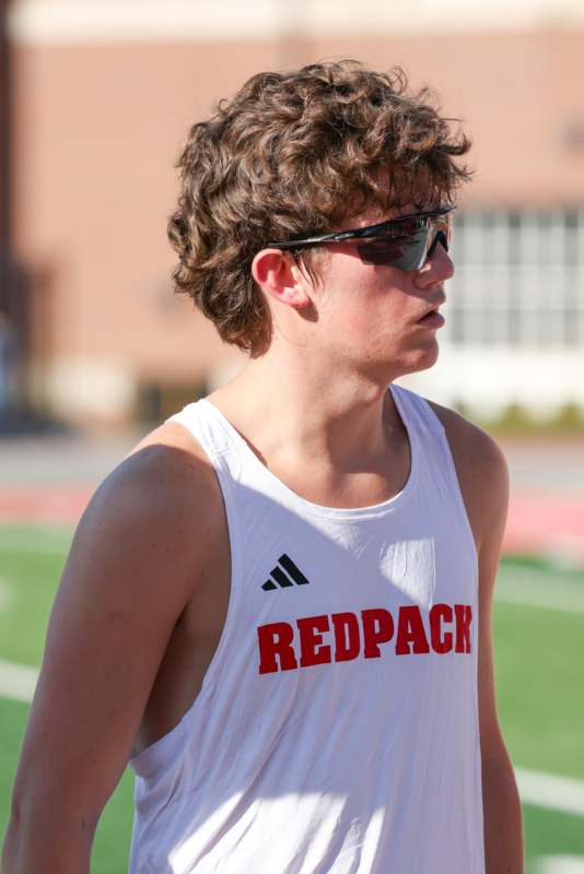 a man wearing sunglasses and a tank top