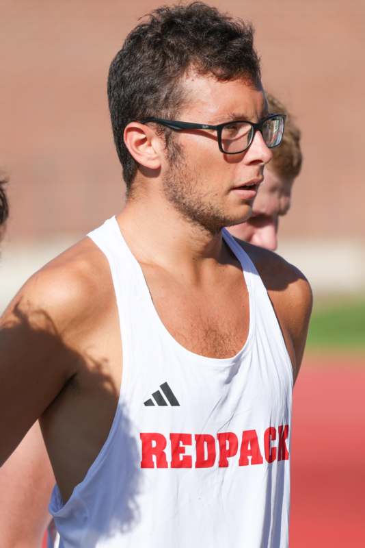 a man in a white tank top