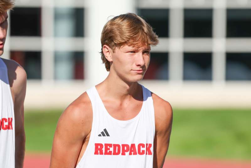 a man in a white tank top