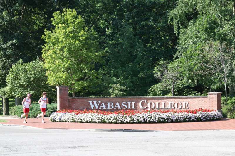 a sign with a person walking in front of a sign