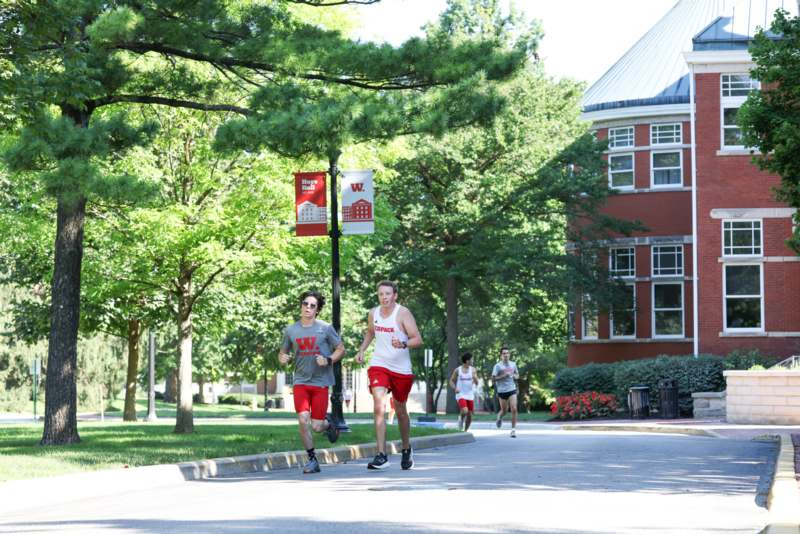 a group of people running on a street
