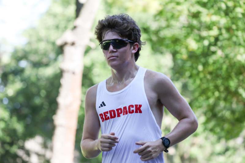 a man running in a tank top