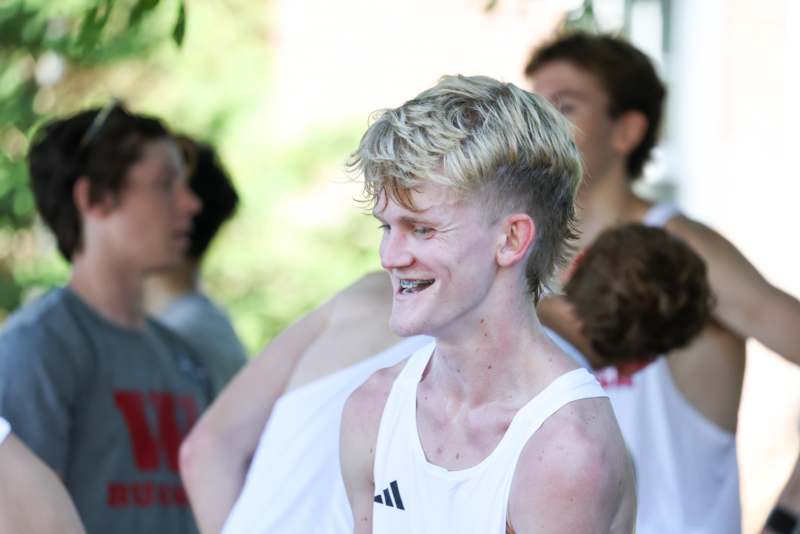a man in a white tank top