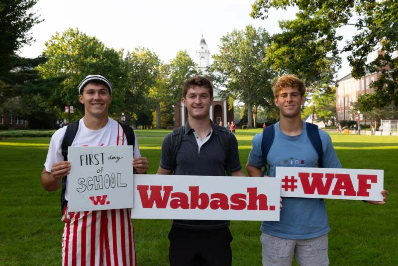 a group of men holding signs