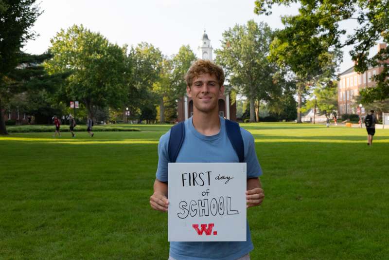 a man holding a sign in front of a building