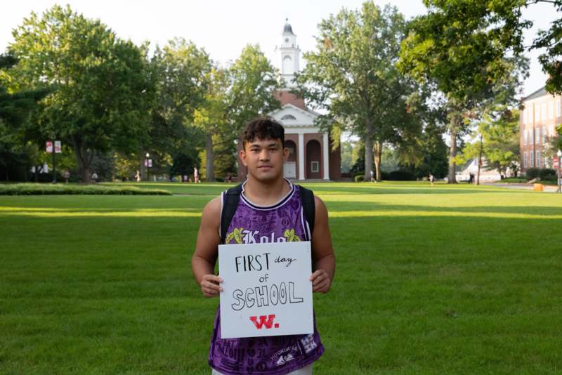 a man holding a sign in front of a building
