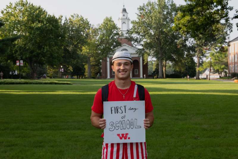 a man holding a sign in front of a building