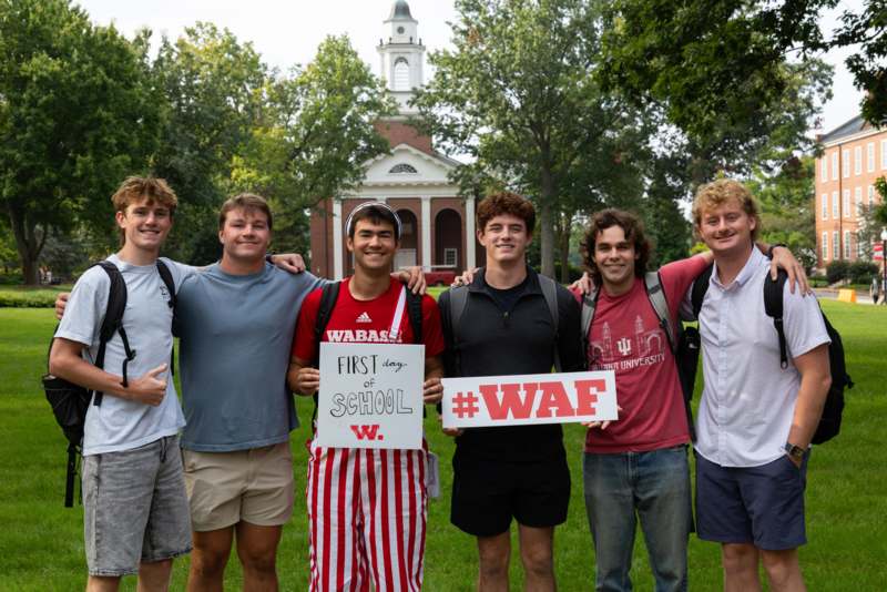 a group of men standing in front of a building