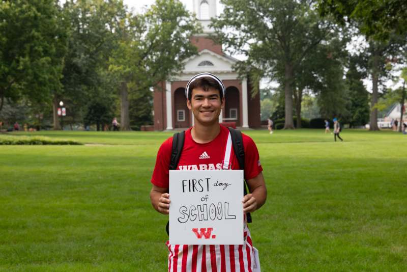 a man holding a sign in front of a building