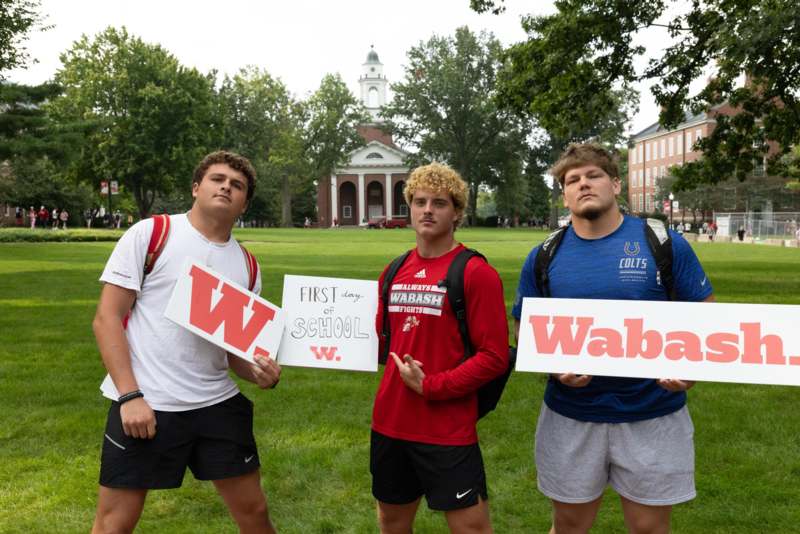 a group of men holding signs