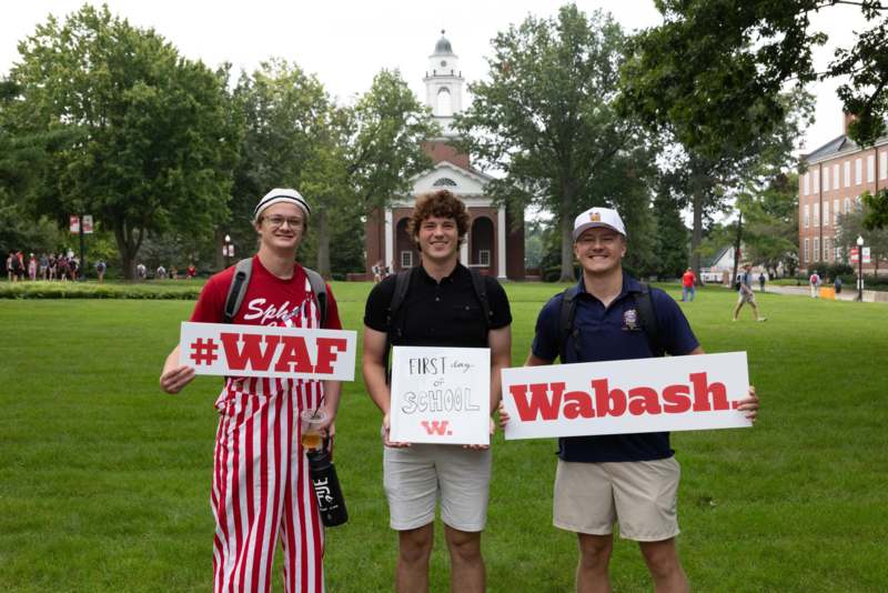 a group of men holding signs