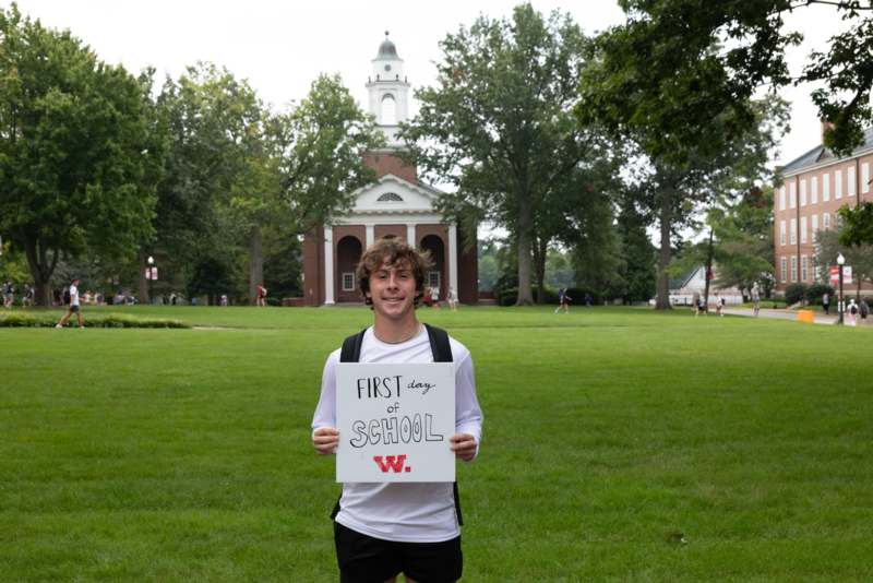 a man holding a sign in front of a building