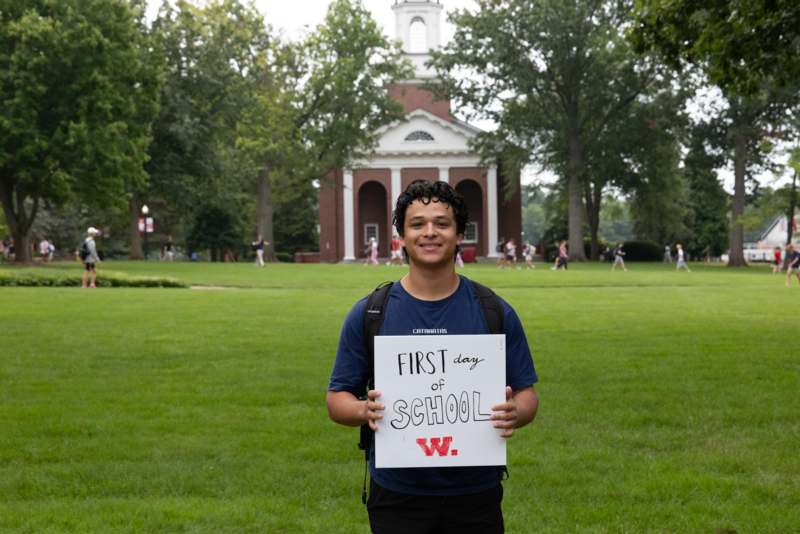 a man holding a sign in front of a building
