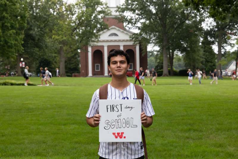 a man holding a sign in front of a building