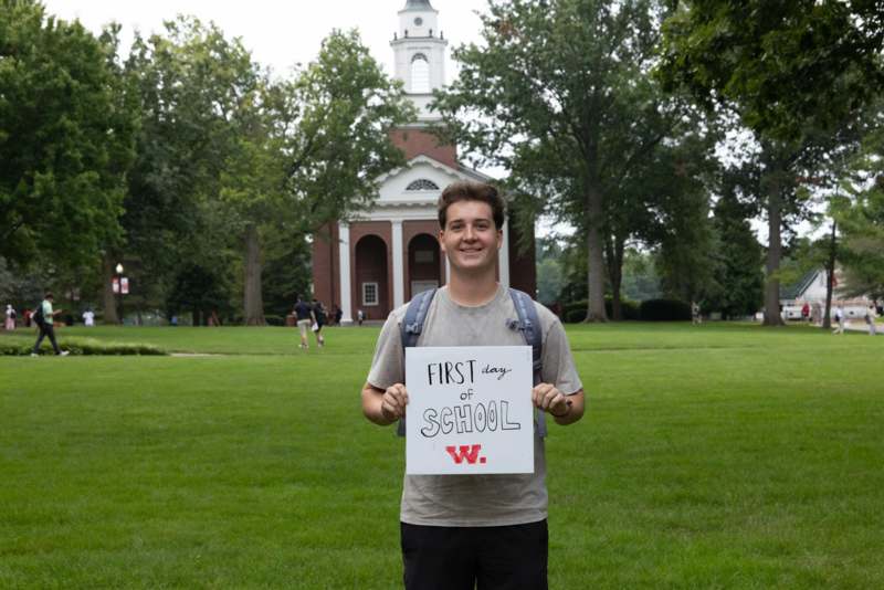 a man holding a sign in front of a building