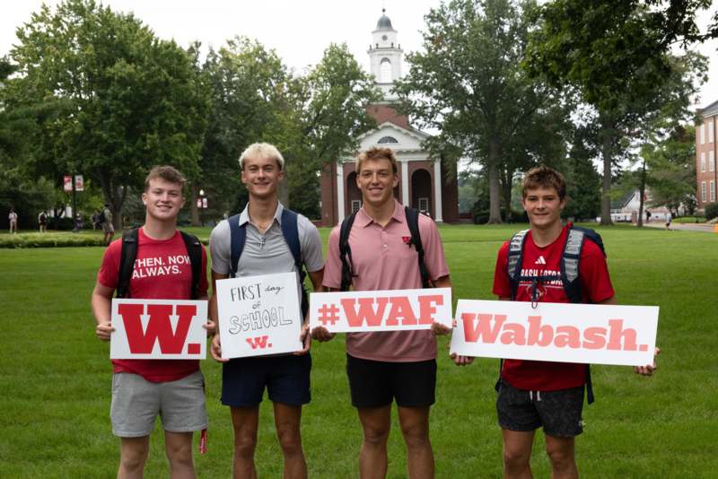 a group of men holding signs