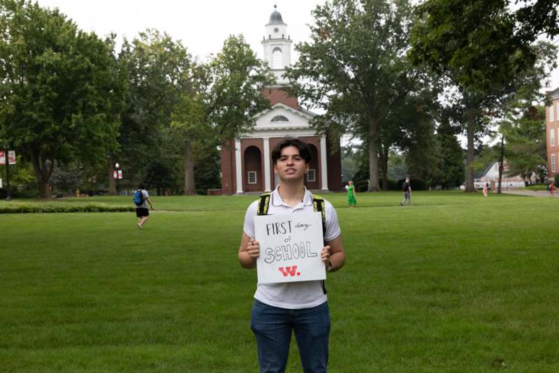 a man holding a sign in front of a building