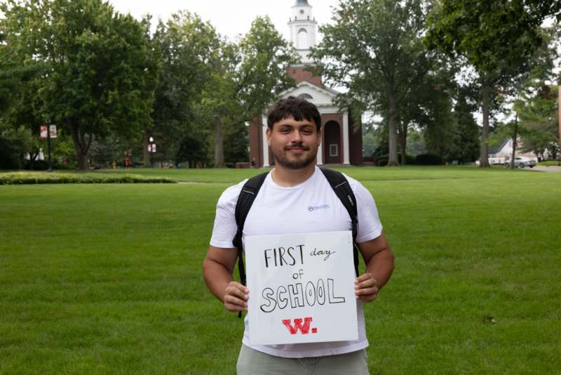 a man holding a sign in front of a building