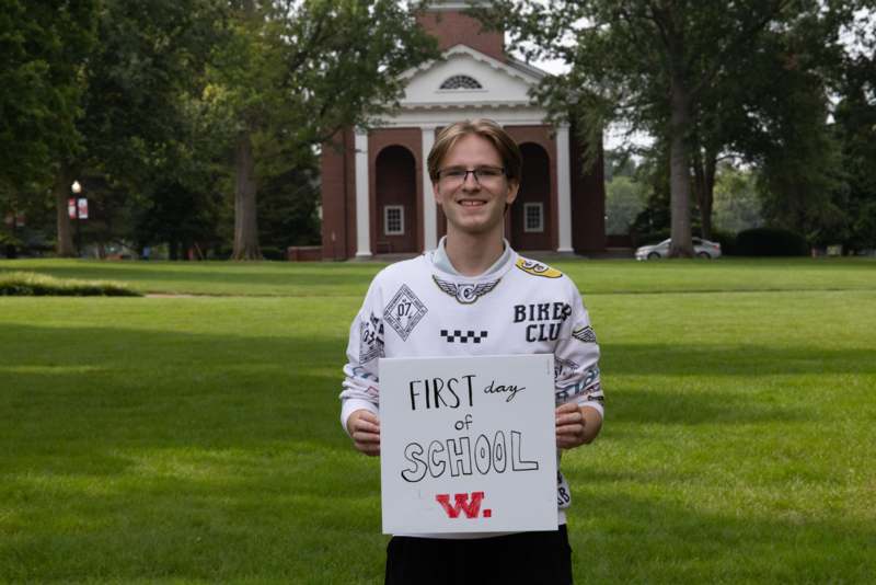 a man holding a sign in front of a building