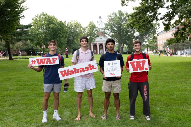 a group of men holding signs in front of a building