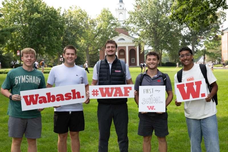 a group of men holding signs