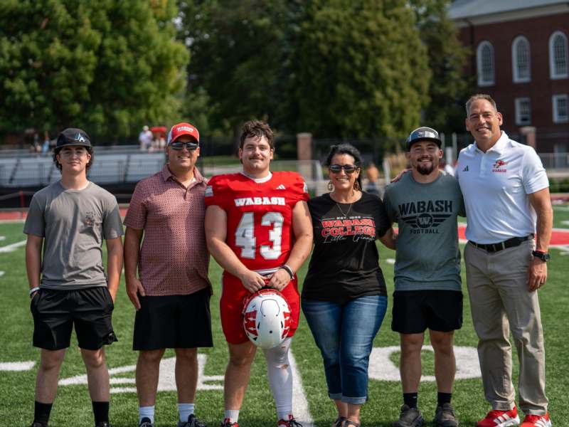 a group of people standing on a football field