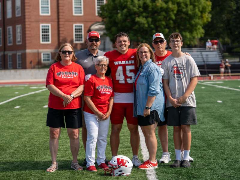 a group of people posing for a photo on a football field