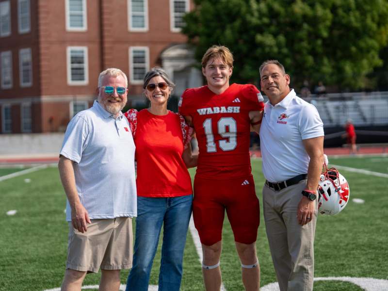 a group of people posing for a photo on a football field