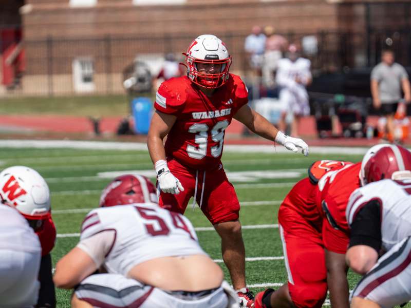 a football player in red uniform on a field