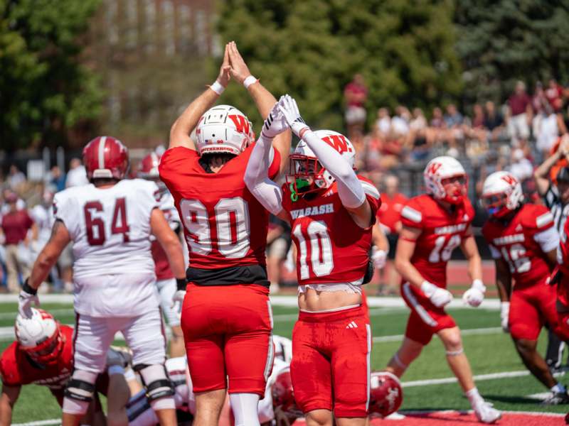 a group of football players high fiving